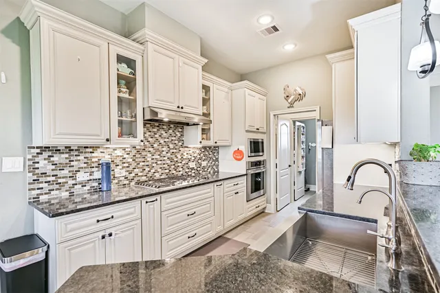 a view of walk in closet with clothes