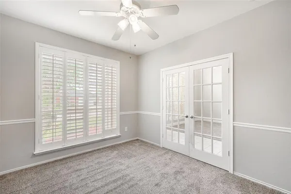 a view of an empty room with a ceiling fan