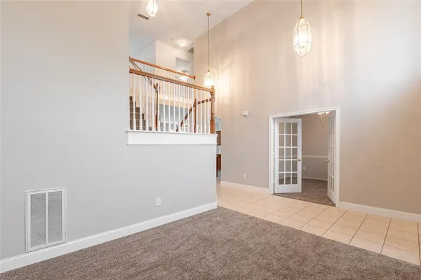 an empty room with fireplace and windows