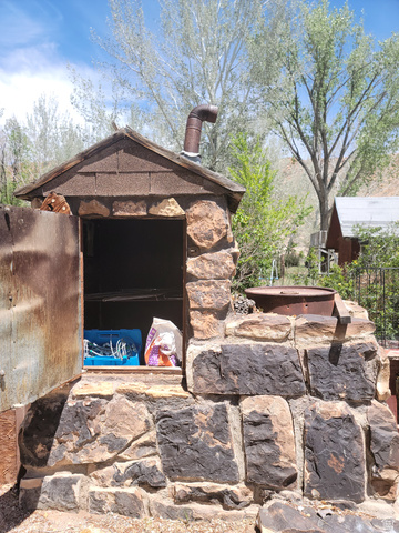 10429 4th Street East Randlett, UT 84063 - Photo 18 of 19 Smokehouse featuring a shingled roof and integrated metal chimney