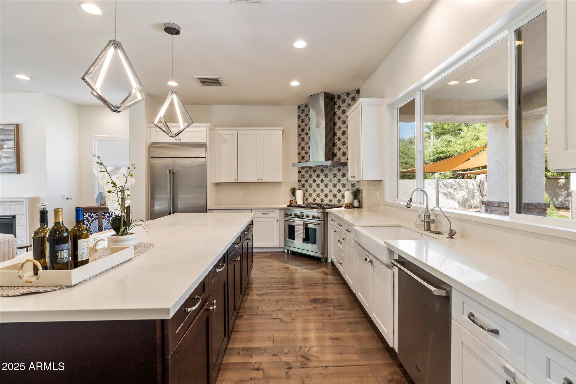 640 West Echo Lane Phoenix, AZ 85021 - Photo 12 of 55 a large kitchen with kitchen island a large counter space a sink appliances and a counter top space