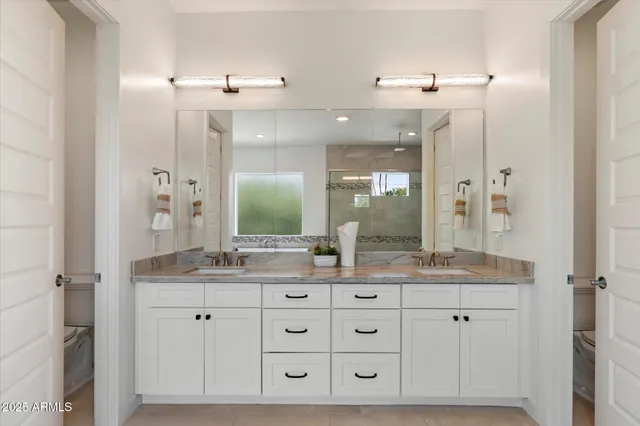 a bathroom with a tub a sink and a shower