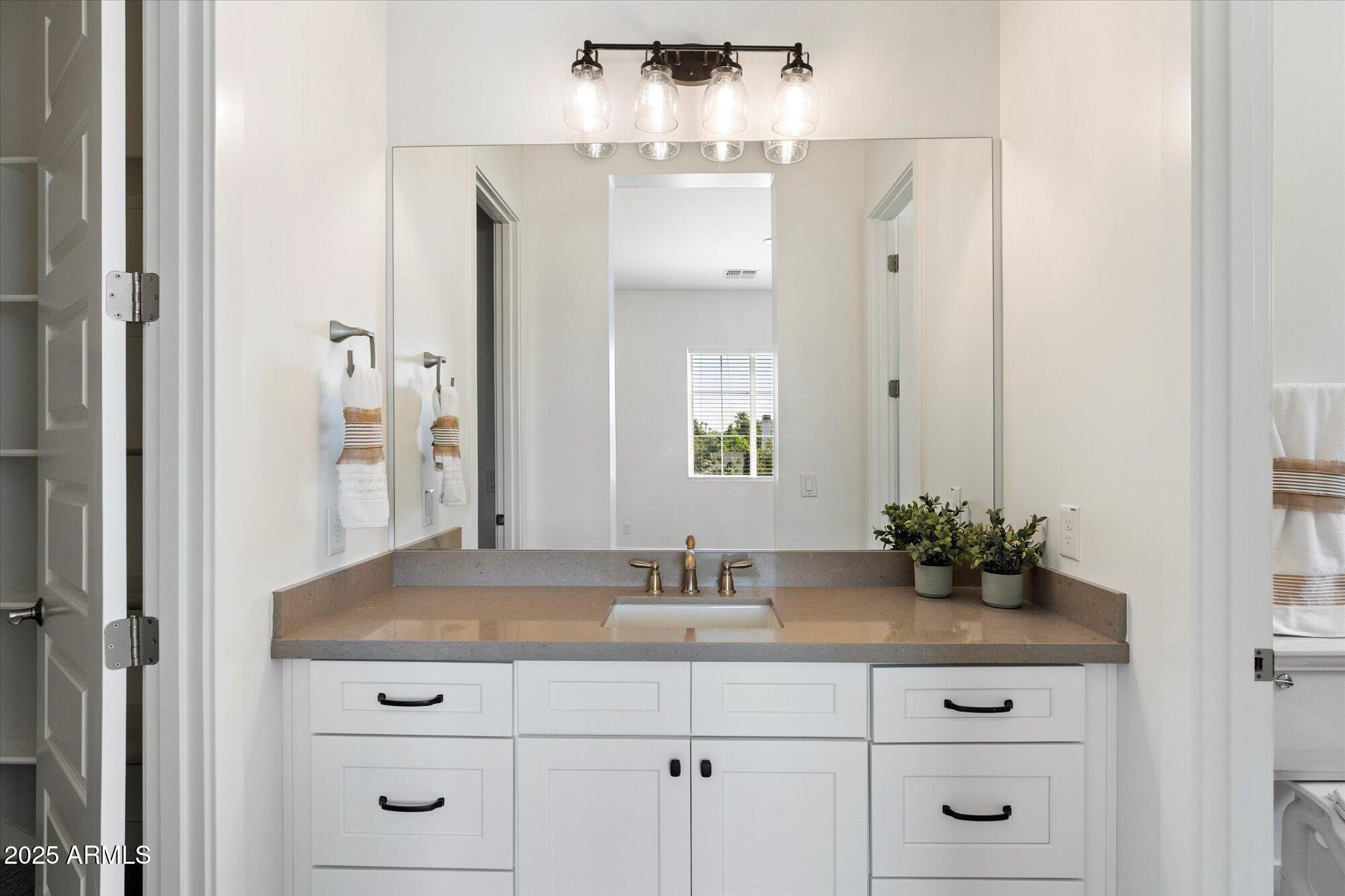 640 West Echo Lane Phoenix, AZ 85021 - Photo 32 of 55 a bathroom with a sink vanity and a mirror