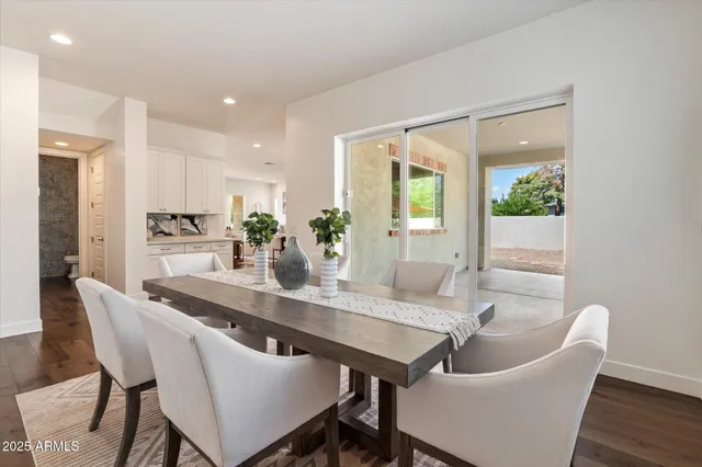 a dining room with furniture and wooden floor