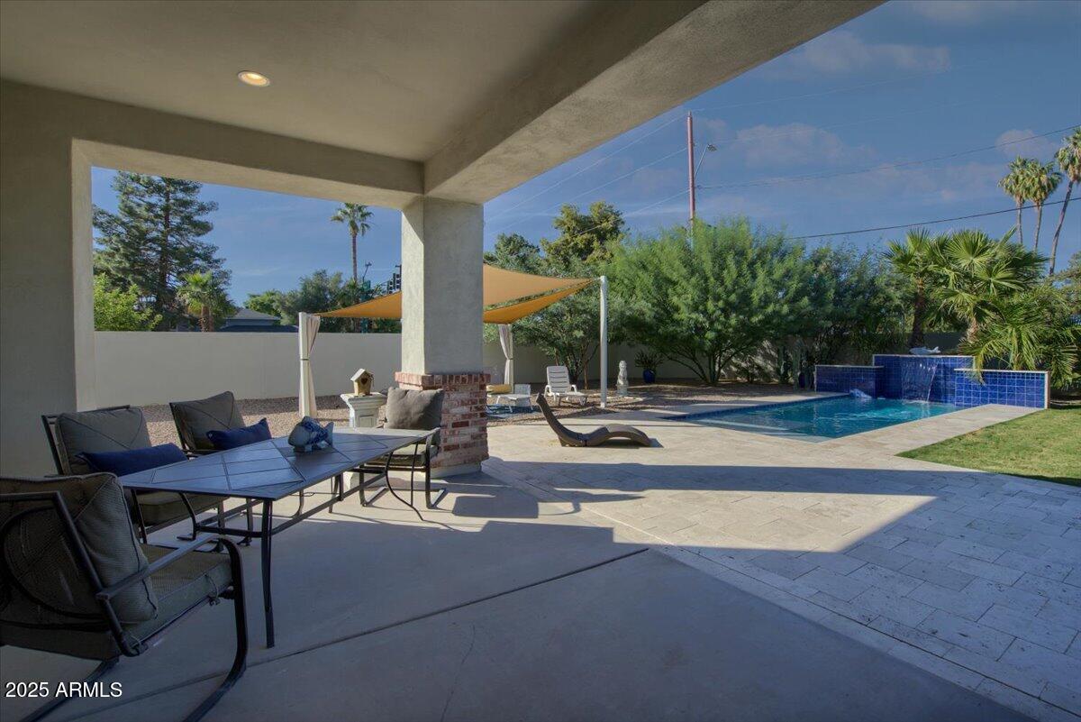 640 West Echo Lane Phoenix, AZ 85021 - Photo 42 of 55 a view of a patio with table and chairs potted plants with wooden floor