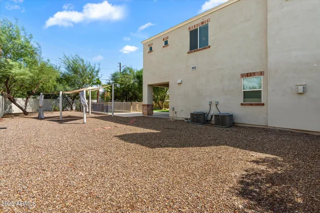 a view of a house with backyard and a tree