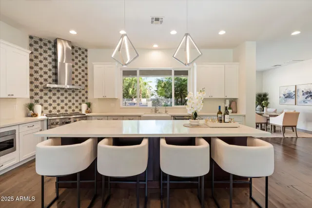 a large kitchen with a table and chairs