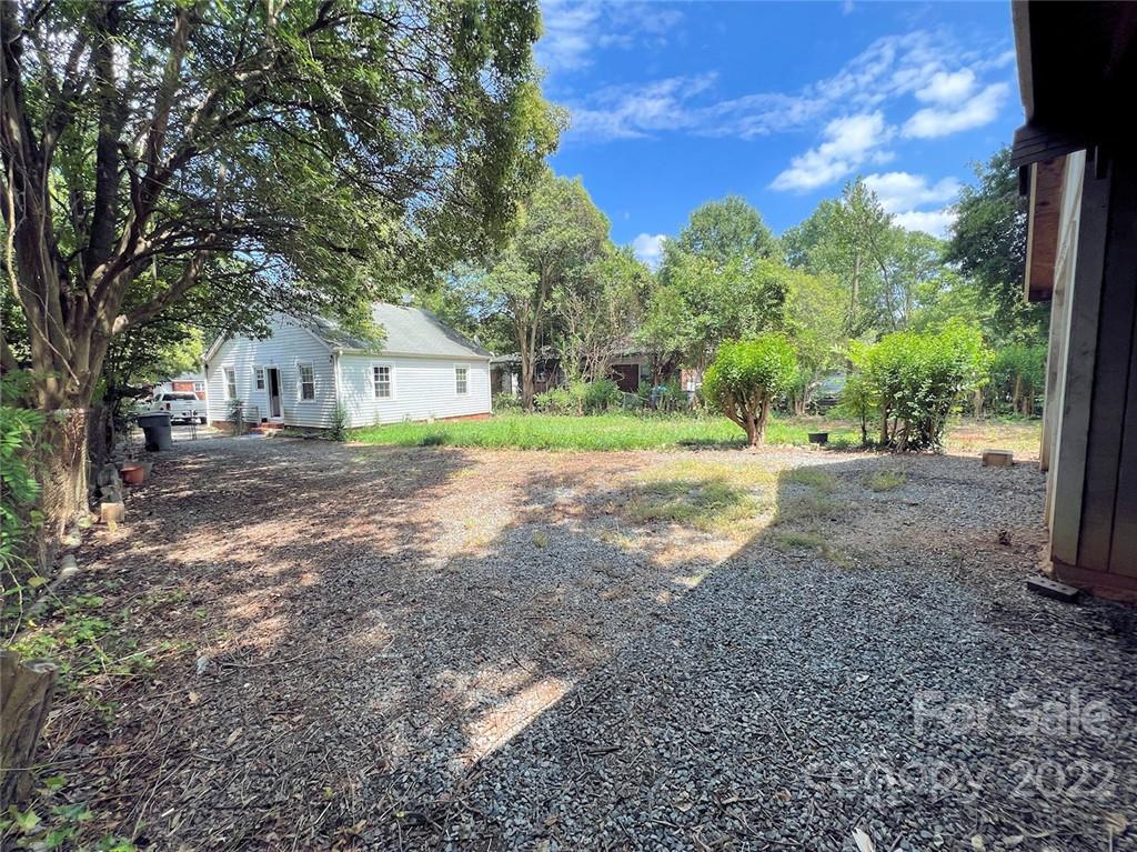 1322 Shamrock Drive Charlotte, NC 28205 - Photo 13 of 21 a front view of a house with a yard and trees