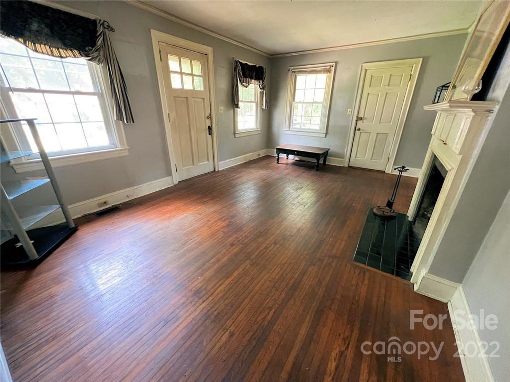 1322 Shamrock Drive Charlotte, NC 28205 - Photo 14 of 21 a view of an empty room with wooden floor and windows
