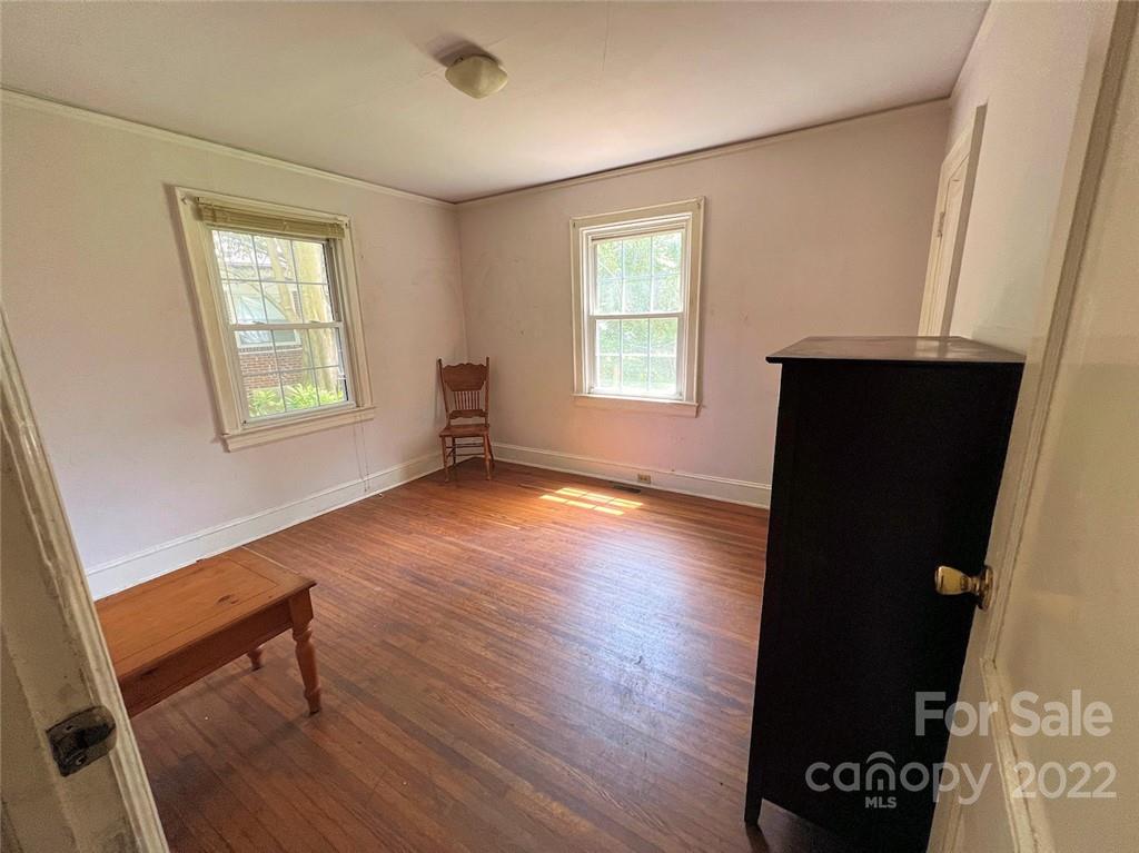 1322 Shamrock Drive Charlotte, NC 28205 - Photo 16 of 21 a view of an empty room with a window and wooden floor
