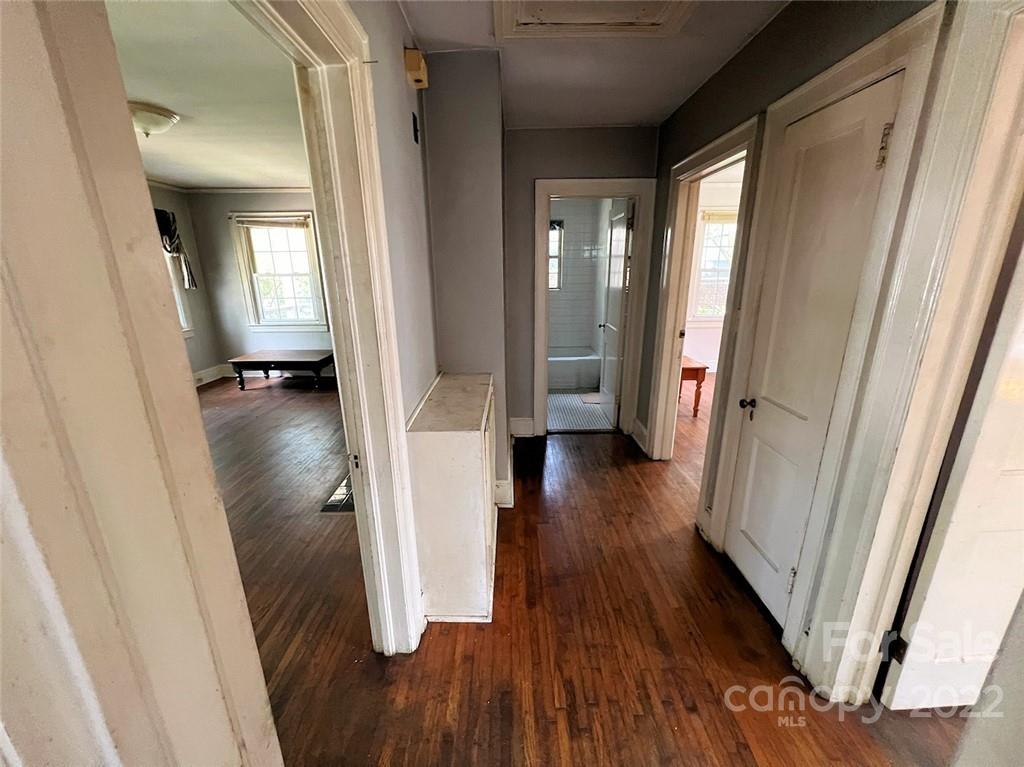 1322 Shamrock Drive Charlotte, NC 28205 - Photo 18 of 21 a view of a hallway with wooden floor and stairs