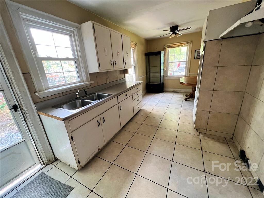 1322 Shamrock Drive Charlotte, NC 28205 - Photo 20 of 21 a kitchen with a sink a stove and a window