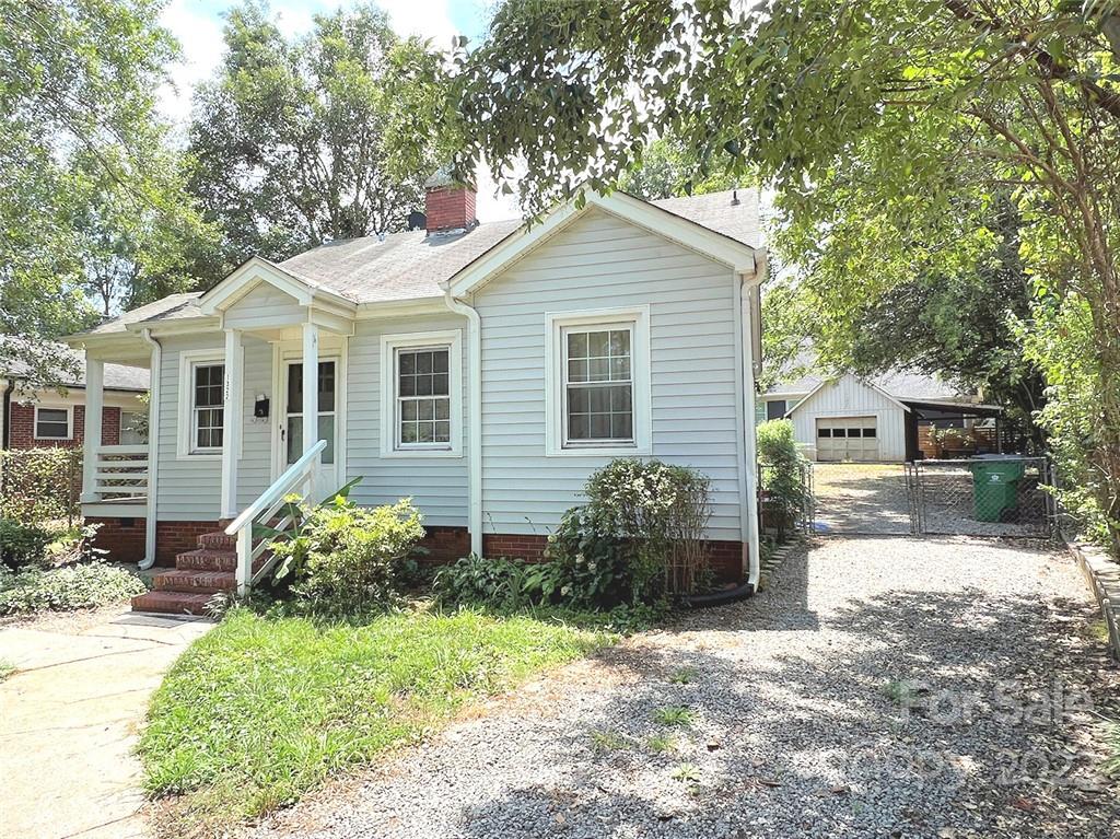 1322 Shamrock Drive Charlotte, NC 28205 - Photo 2 of 21 a front view of a house with garden