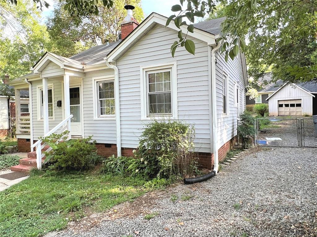 1322 Shamrock Drive Charlotte, NC 28205 - Photo 3 of 21 a view of a yard in front of a house with plants and large tree