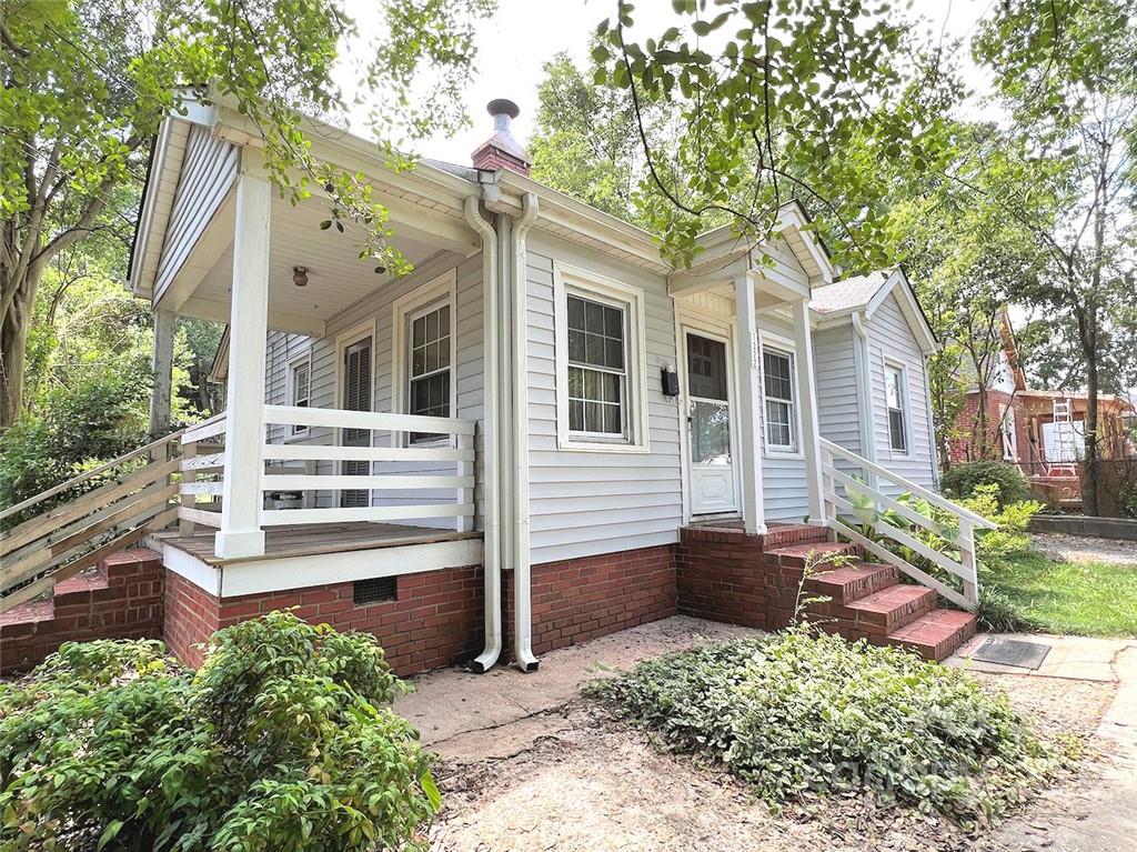 1322 Shamrock Drive Charlotte, NC 28205 - Photo 4 of 21 a view of a house with a small yard and potted plants