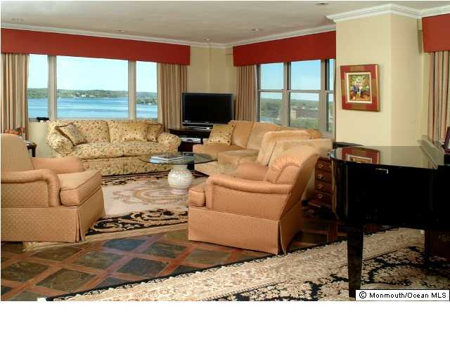 28 Riverside Avenue, Unit 12A Red Bank, NJ 07701 - Photo 2 of 3 a living room with furniture window and a flat screen tv