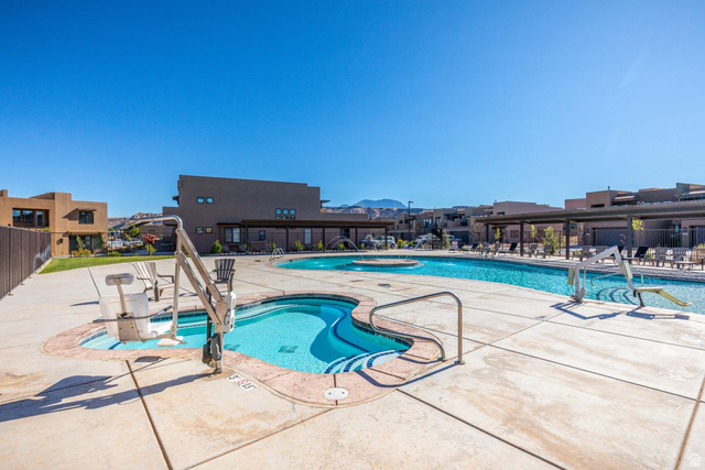 4845 Fishers Is Way St. George, UT 84770 - Photo 40 of 41 Community pool featuring a patio area and a hot tub