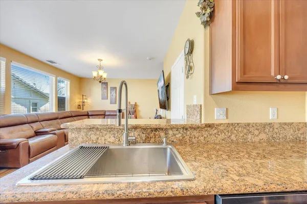 a view of kitchen with kitchen island a sink and a counter top space