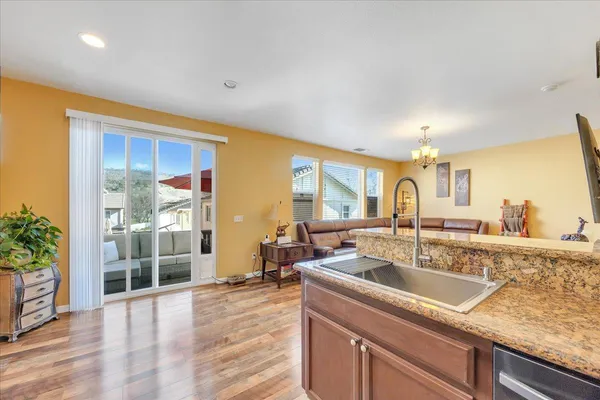 a kitchen with granite countertop a sink and cabinets