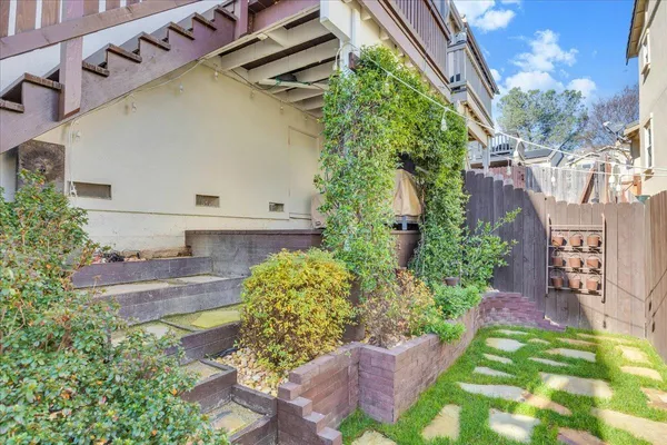 a view of a house with wooden deck and furniture