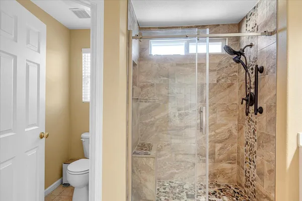 a bathroom with a sink toilet and shower