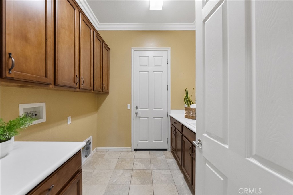 1669 Via Simpatico Hemet, CA 92545 - Photo 23 of 58 Laundry with direct access to garage, sink and lots of storage!