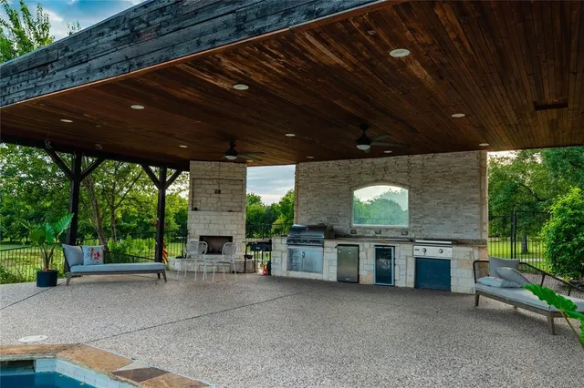 a view of a porch with furniture and a backyard