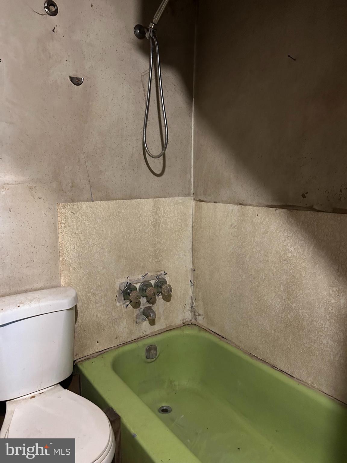 3950 Faith Lane Huntingtown, MD 20639 - Photo 7 of 8 a white toilet sitting next to a bath tub and a shower