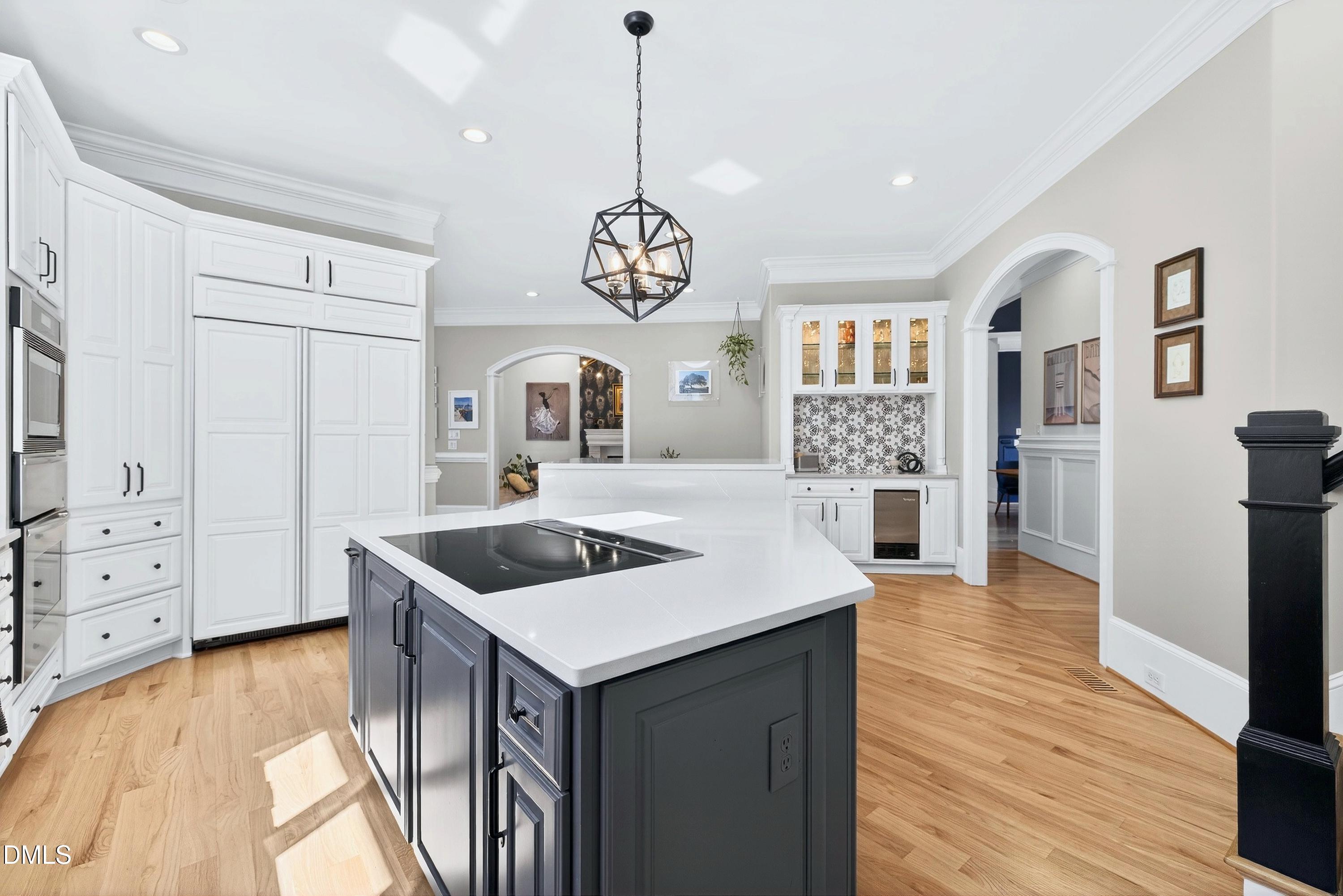 6701 Foxfire Place Raleigh, NC 27615 - Photo 22 of 67 a kitchen that has a lot of cabinets in it and wooden floors