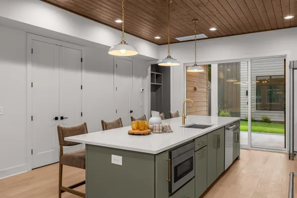a kitchen with a sink cabinets and wooden floor
