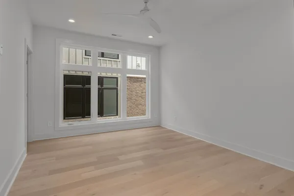 a view of an empty room with a kitchen