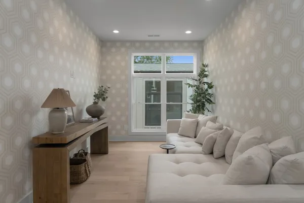 a living room with furniture and a potted plant