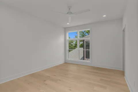 an empty room with windows and closet