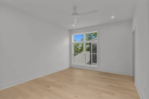 an empty room with windows and closet