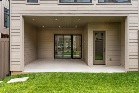 a view of a house with backyard and porch