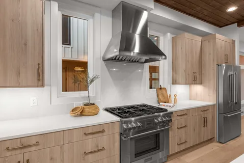 a kitchen with stainless steel appliances a sink stove and cabinets