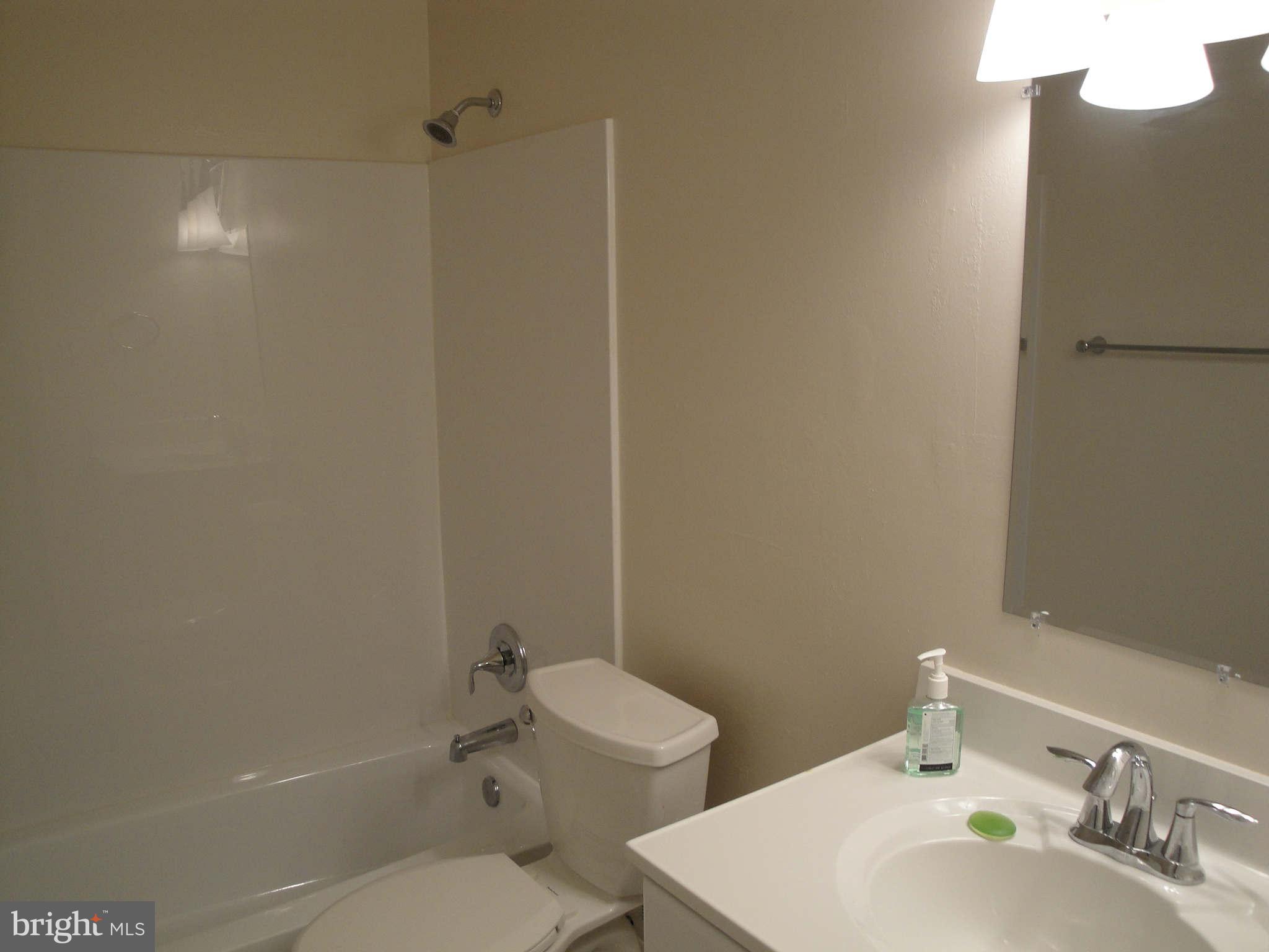 13212 Tamarack Road Silver Spring, MD 20904 - Photo 11 of 28 a bathroom with a toilet a sink and mirror