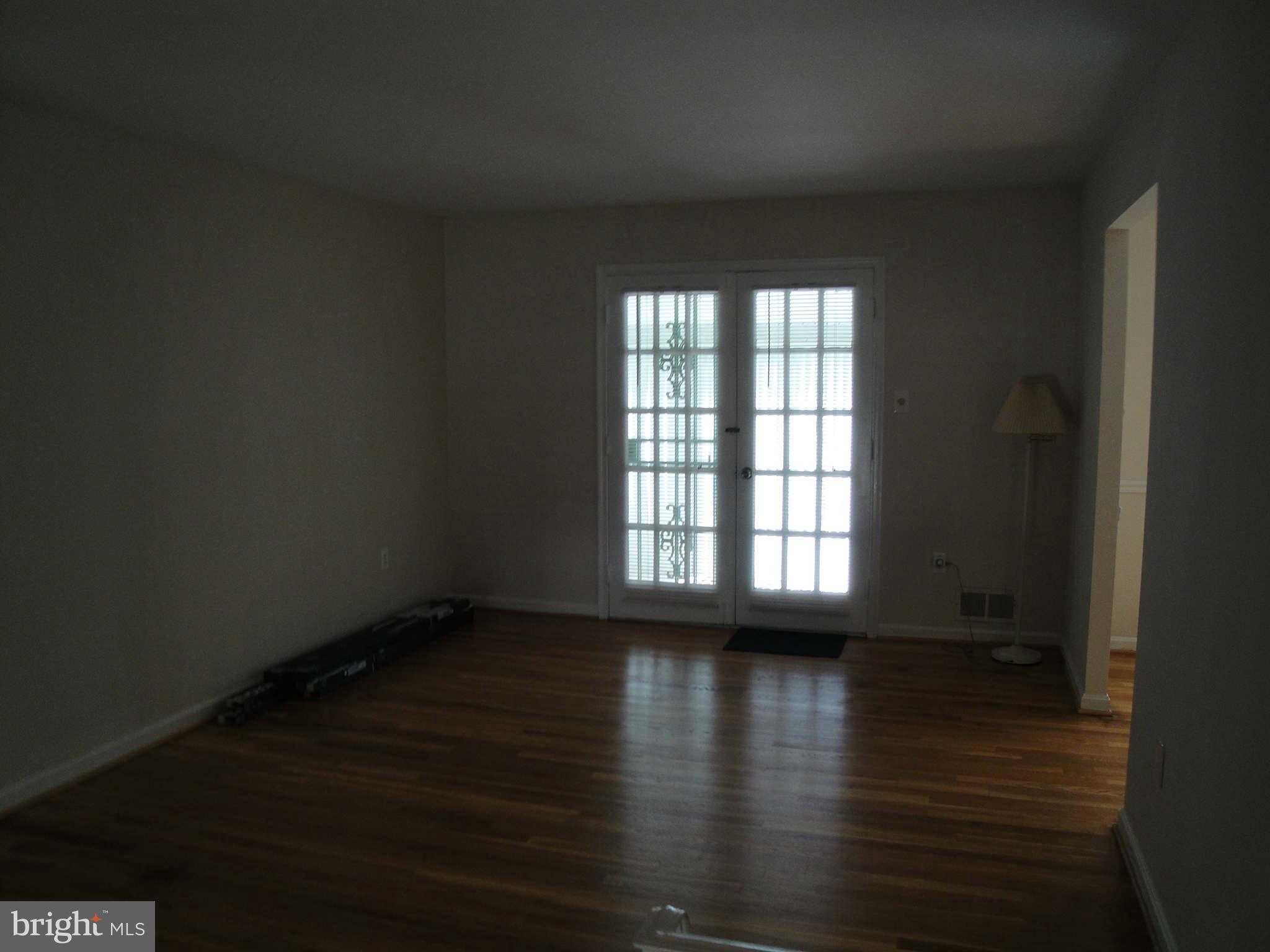 13212 Tamarack Road Silver Spring, MD 20904 - Photo 27 of 28 a view of an empty room with wooden floor and a window