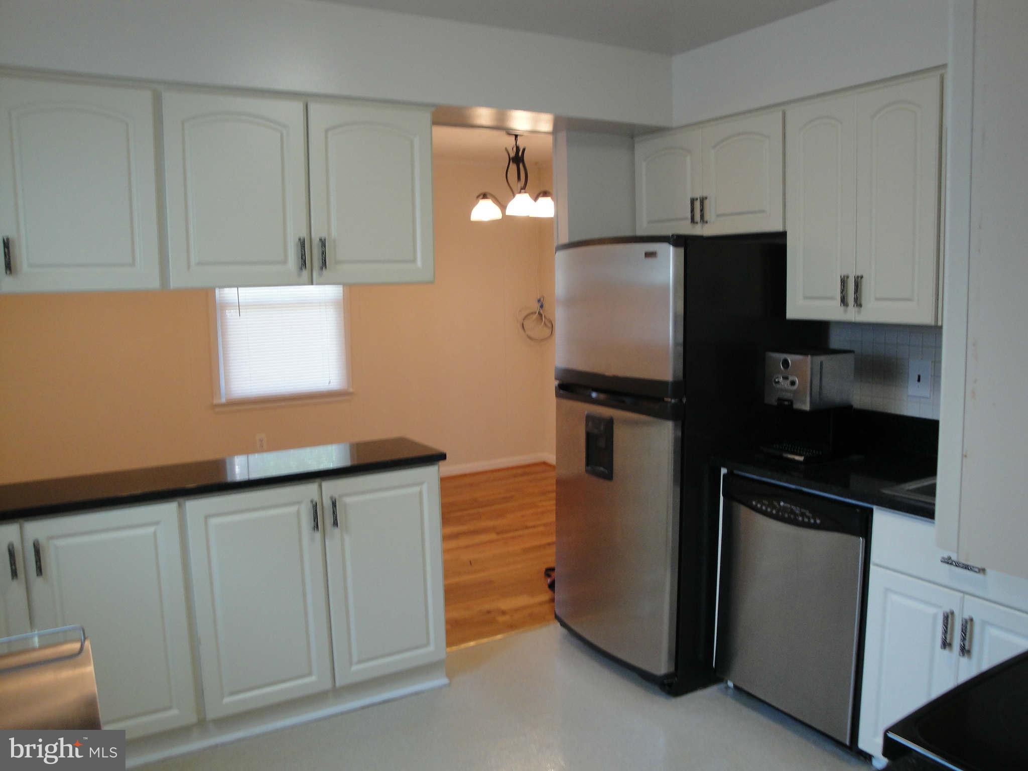 13212 Tamarack Road Silver Spring, MD 20904 - Photo 4 of 28 a kitchen with granite countertop cabinets and refrigerator