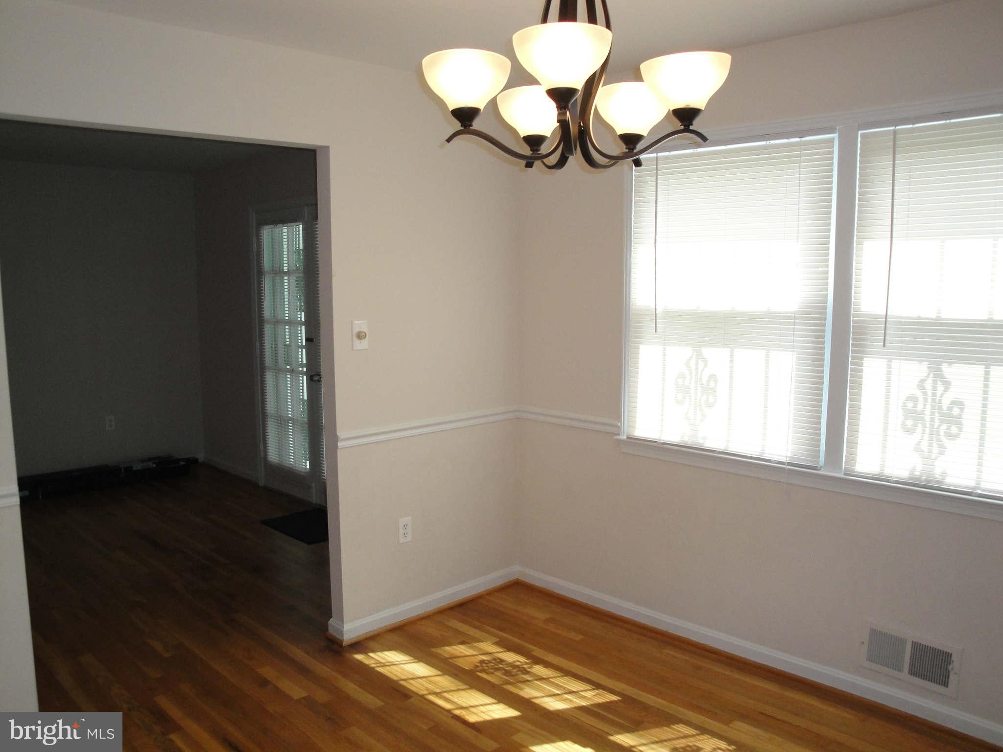 13212 Tamarack Road Silver Spring, MD 20904 - Photo 7 of 28 a view of a chandelier fan and fire place in a room