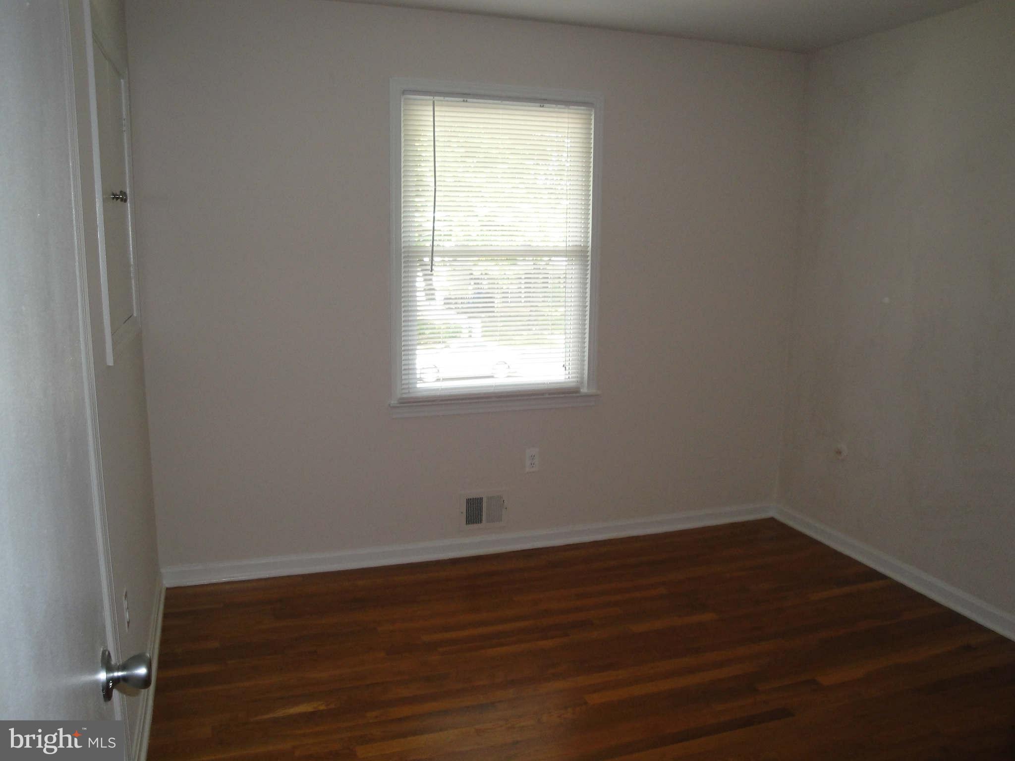 13212 Tamarack Road Silver Spring, MD 20904 - Photo 10 of 28 an empty room with wooden floor and windows