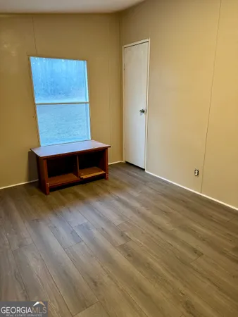 a room with wooden floor and a window