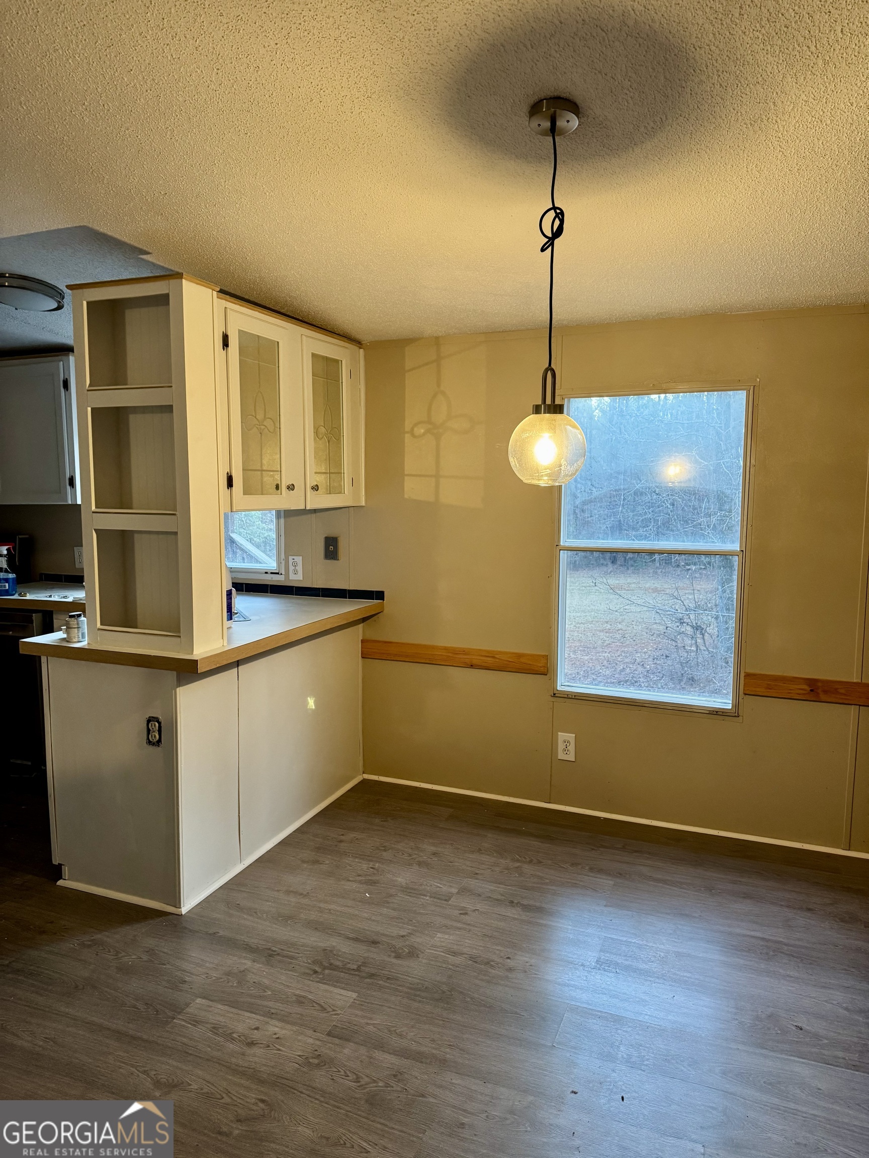 197 Cherokee Trail Forsyth, GA 31029 - Photo 6 of 9 a kitchen with stainless steel appliances granite countertop a sink a stove and a wooden floors