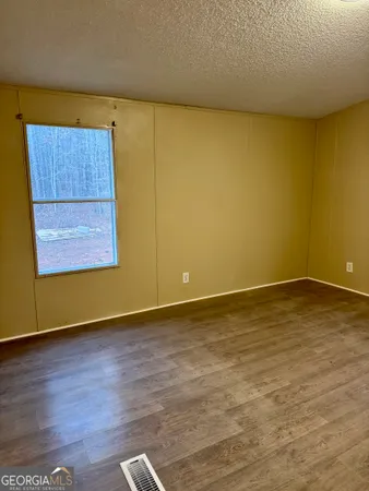a view of an empty room and wooden floor
