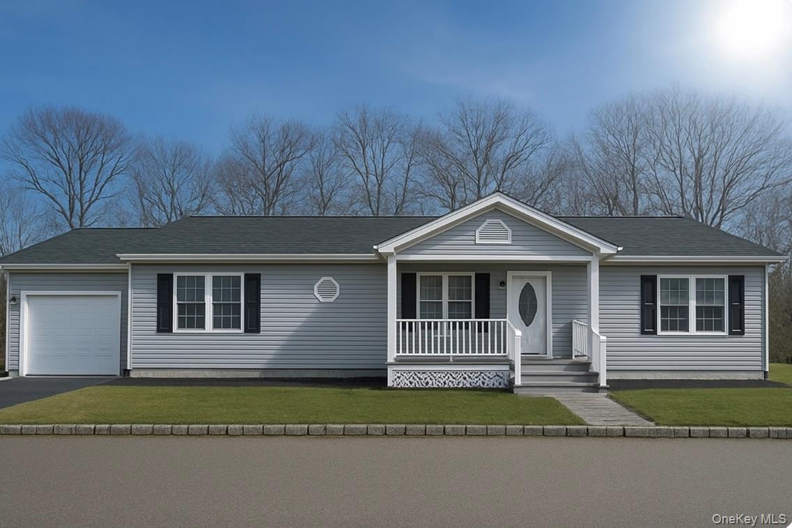 a front view of a house with a garden and trees