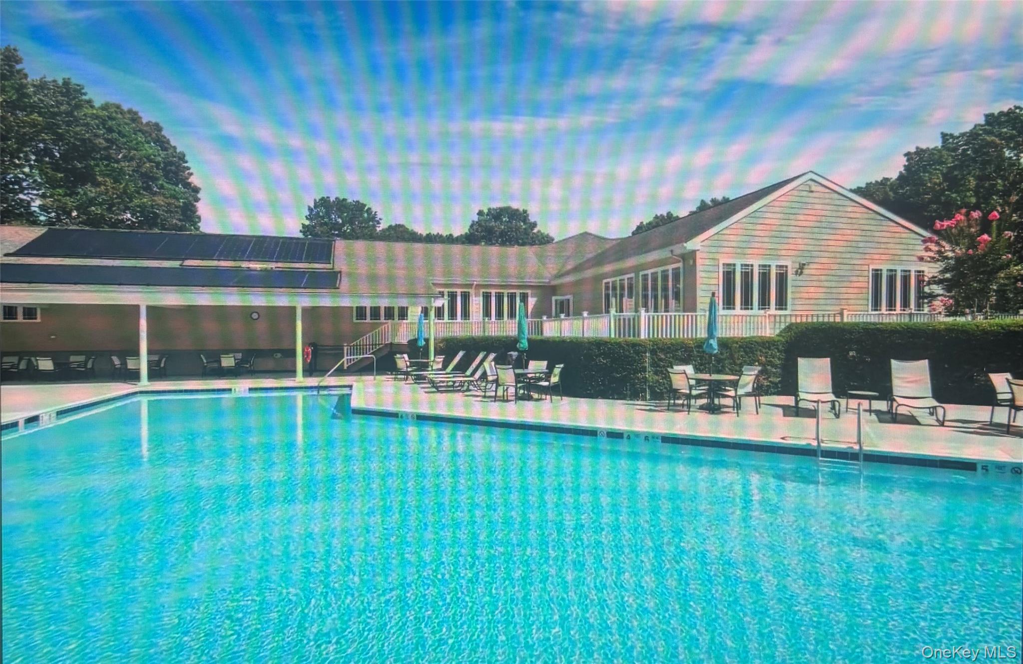 1407 Middle Road, Unit 275 Calverton, NY 11933 - Photo 24 of 24 Pool at dusk with a patio area and a community pool