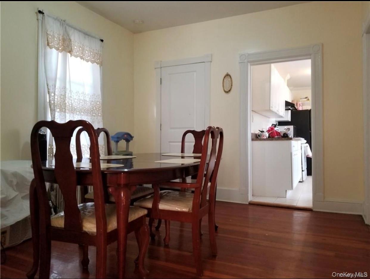 7 Clinton Street Haverstraw, NY 10927 - Photo 14 of 20 Hardwood flooring extends throughout this room, featuring light-colored walls and a window with trim