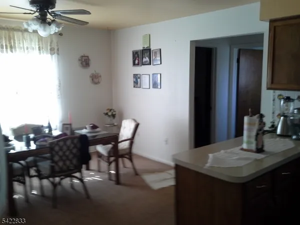 a view of a dining room with furniture and a chandelier