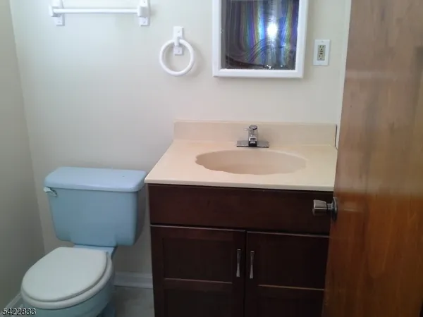 a bathroom with a toilet a sink and mirror