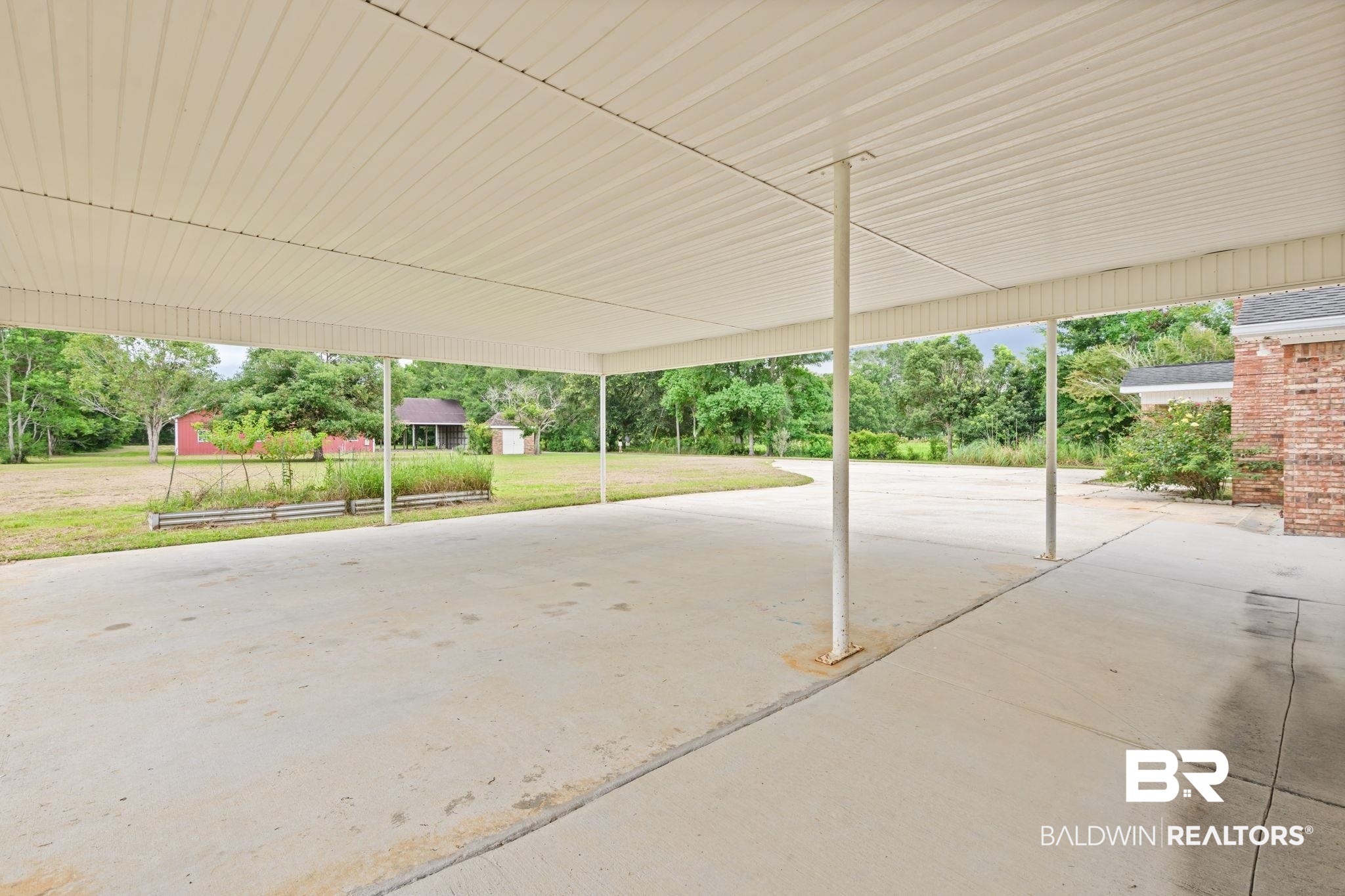 7540 2 Mile Road Irvington, AL 36544 - Photo 58 of 82 Expansive carport with a concrete slab and multiple support columns